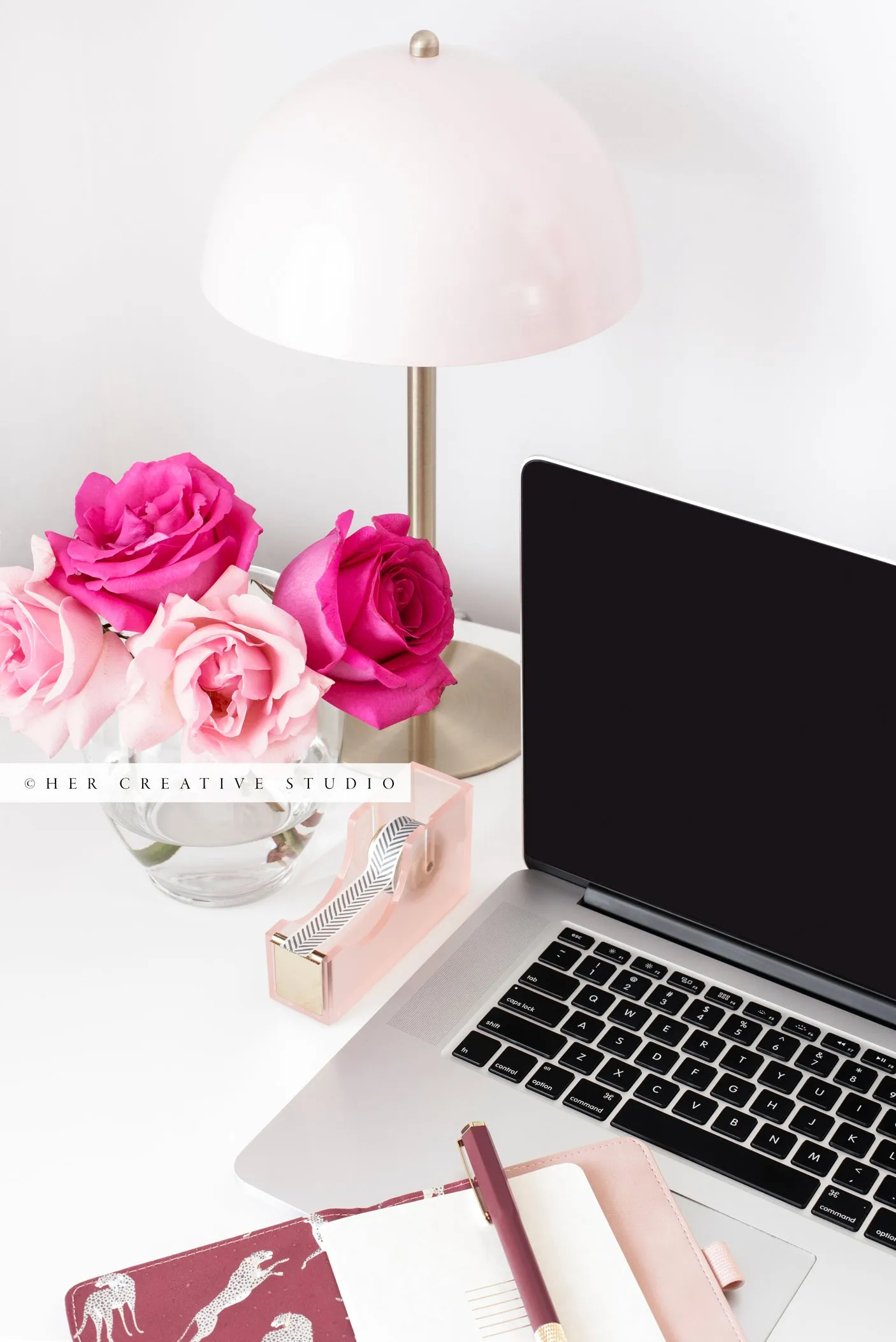 Pink Roses and Laptop on Workspace. Stock Photo