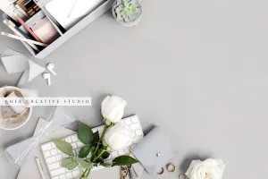 Roses & Keychain on Grey Workspace. Stock Image