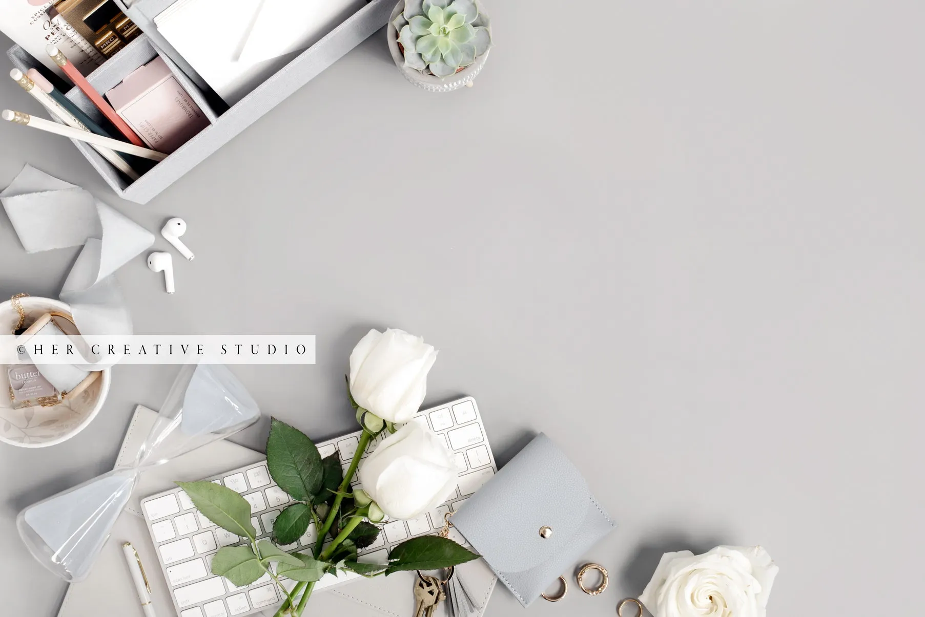 Roses & Keychain on Grey Workspace. Stock Image